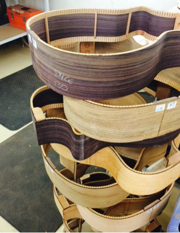 Guitar sides wait for their tops and backs to be placed. 