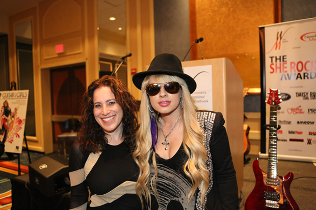 Laura-Whitmore-and-Orianthi-with-guitar-to-the-right.jpg