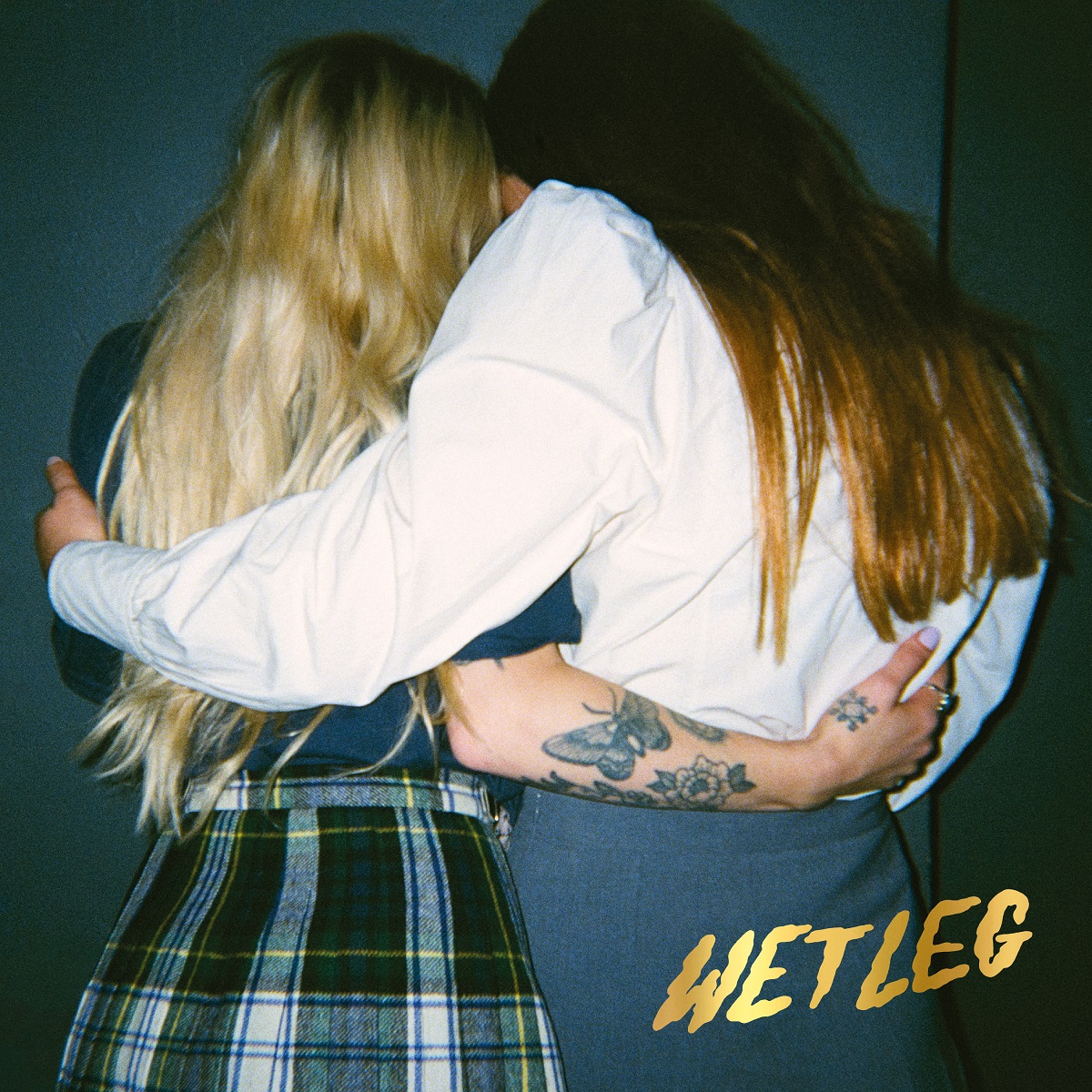 Cover image of Wet Leg debut album; two girls hug with their heads together.