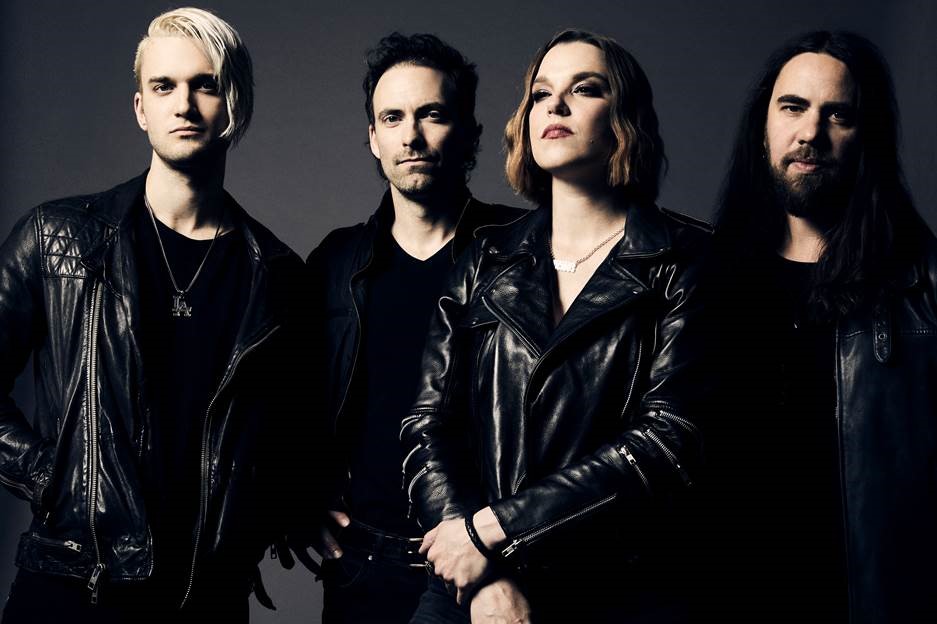 Press photo for Halestorm; a band of 4 people stands against a dark background.