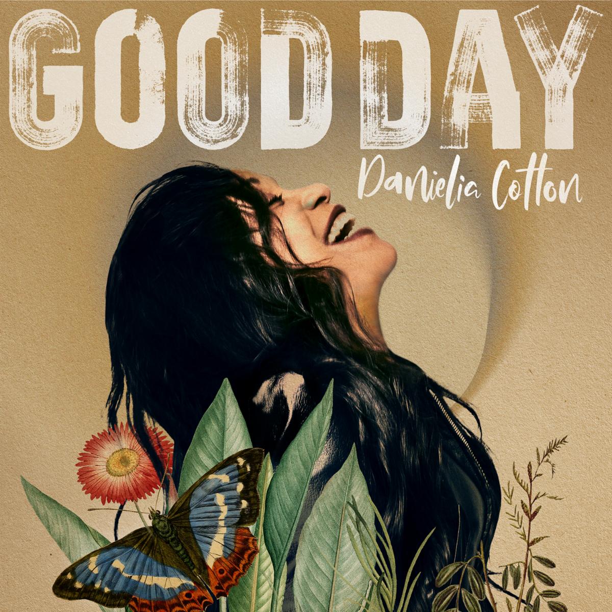 Cover art for Danielia Cotton's "Good Day" single; a woman laughs with her head back, framed by butterflies and green leaves.